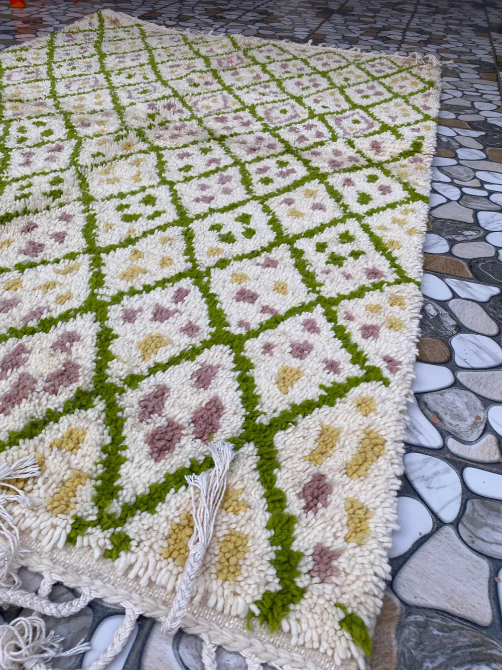 Green Lattice Beni Ourain Rug, seen at an angle on the workshop floor