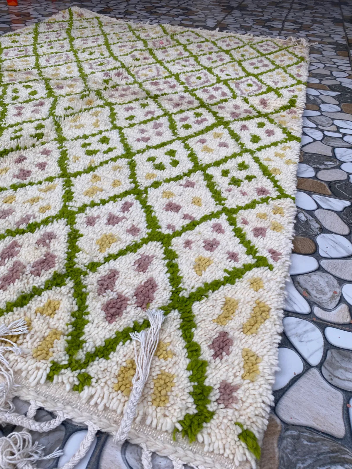 Green Lattice Beni Ourain Rug, seen at an angle on the workshop floor