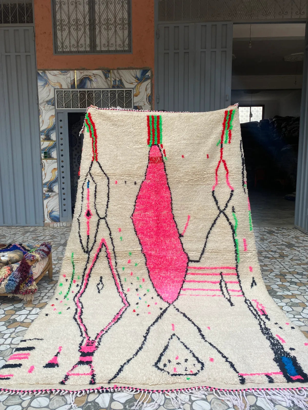 Hot Pink and Ivory Azilal Rug, held up to show the full design