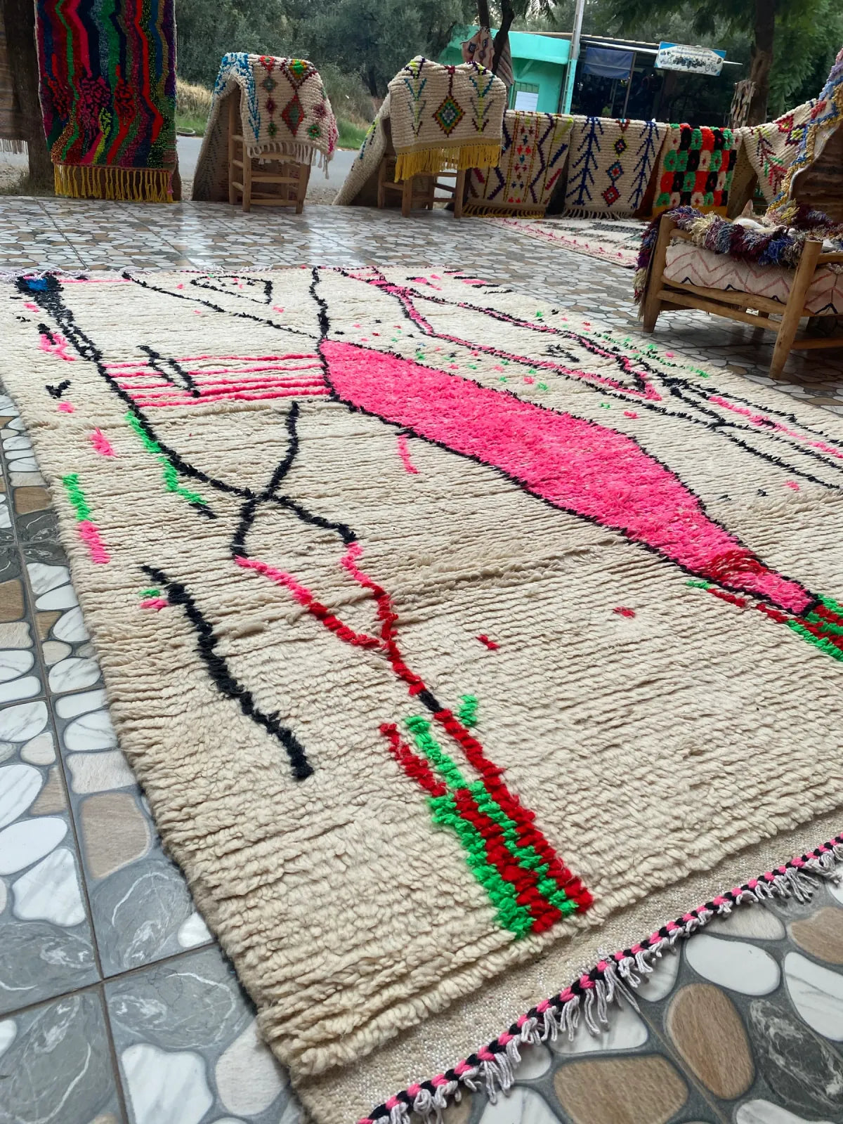 Hot Pink and Ivory Azilal Rug, laid out in the workshop courtyard