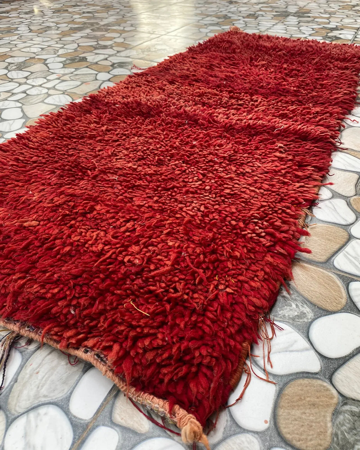 Red Shag Moroccan Runner, seen at an angle on the workshop floor