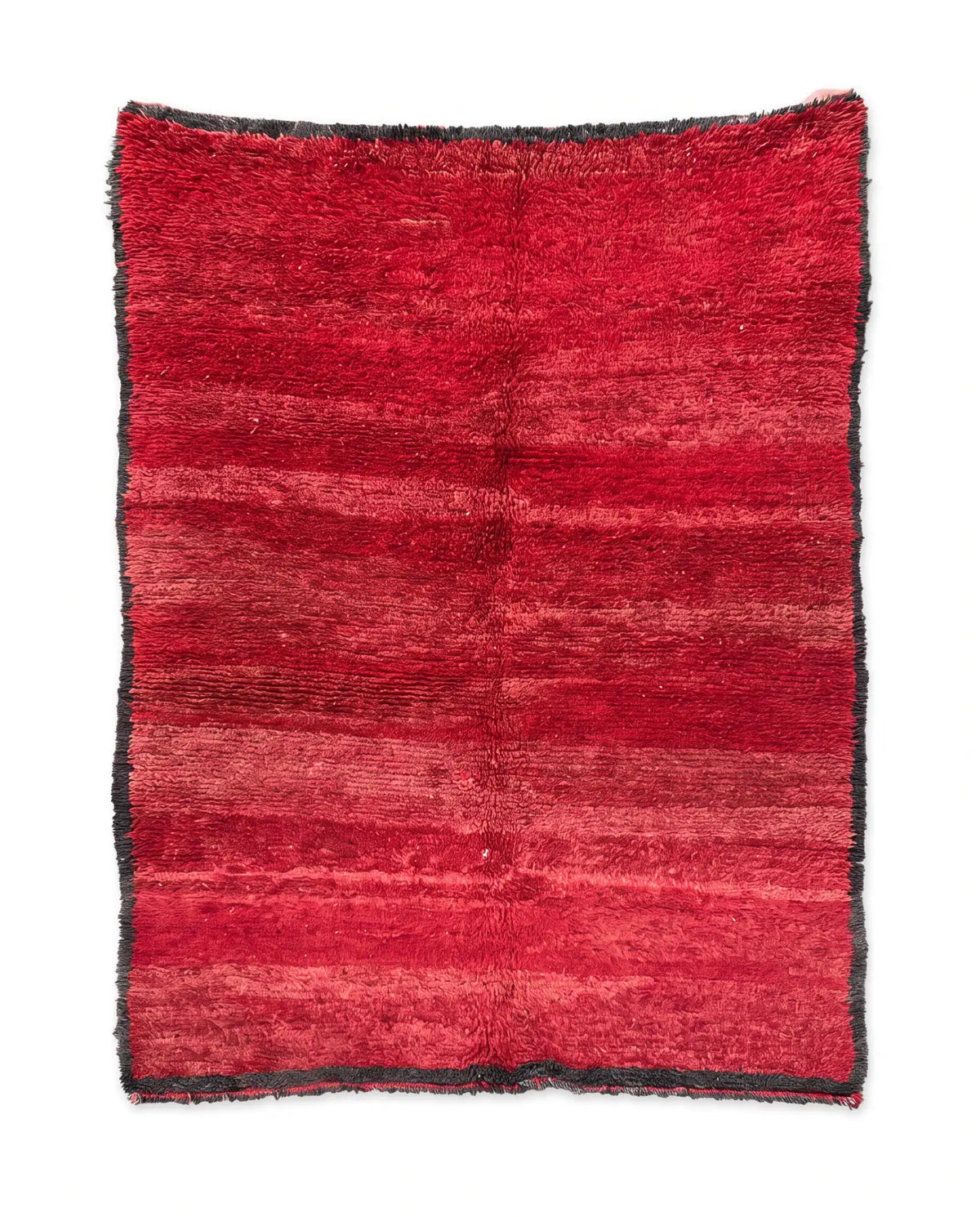 Full view of a red shaggy rug with subtle tonal horizontal stripes and a dark gray border on a white background