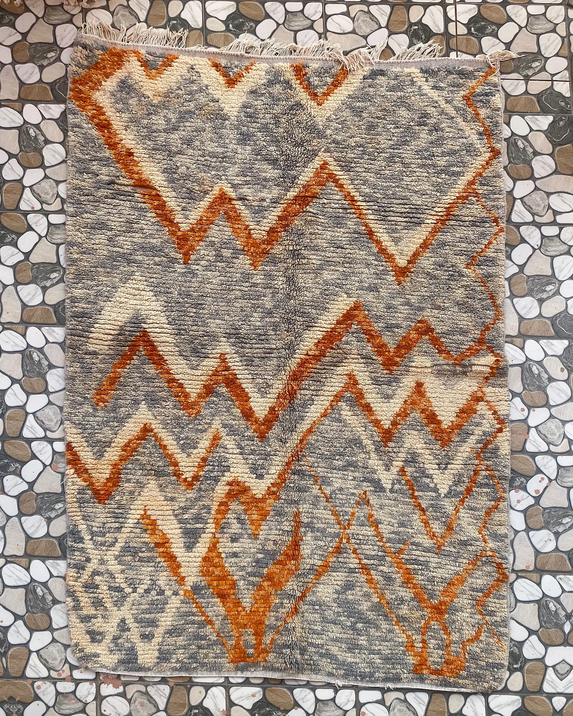 Grey and Orange Zigzag Moroccan Rug, full view laid flat on the workshop floor