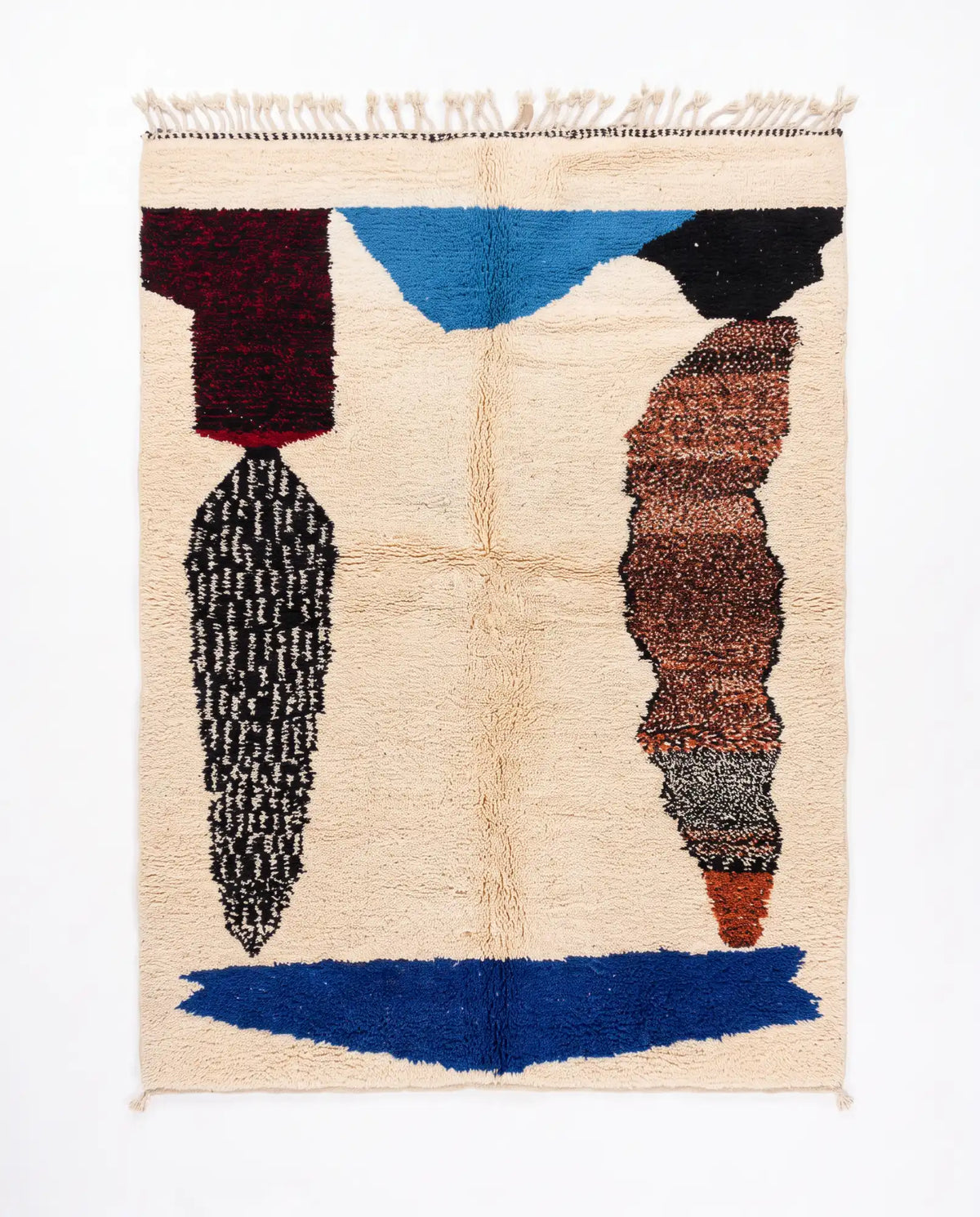 Cream shaggy rug with abstract blue, black, burgundy and brown shapes and fringe, shown flat from above