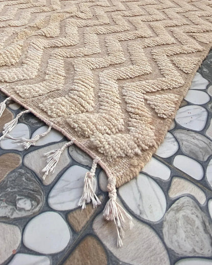 Cream Chevron Beni Ourain Rug, seen at an angle on the workshop floor
