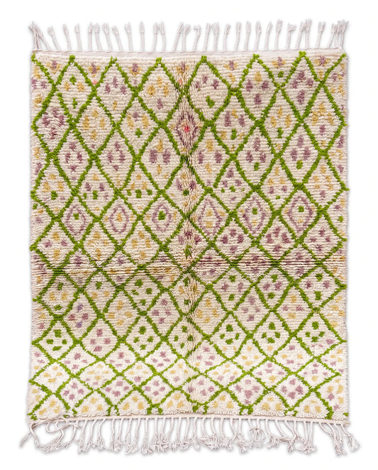 Full view of a cream shaggy wool rug with a green diamond lattice, lilac and yellow dots, and braided white fringe