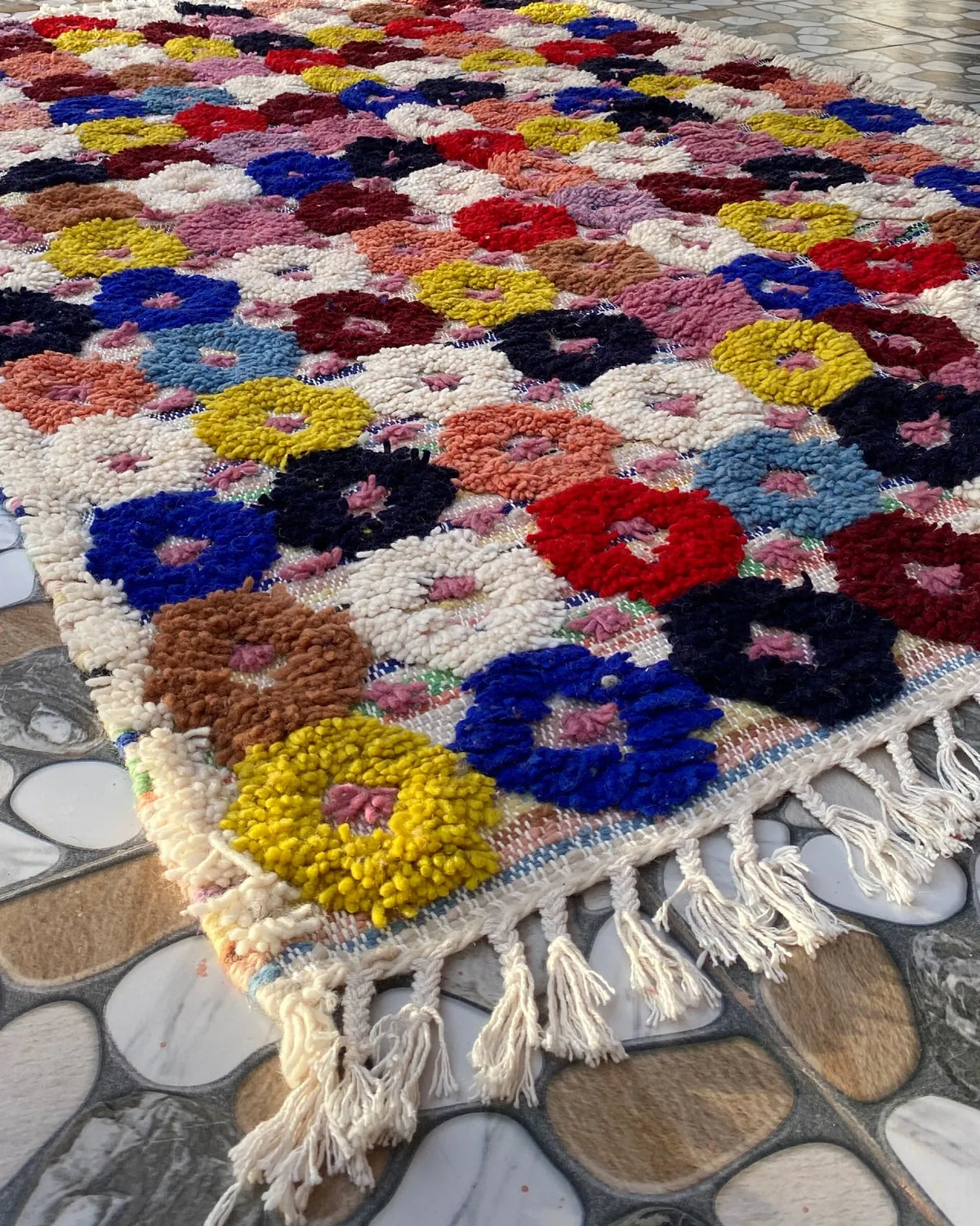 Flower Dot Moroccan Rug, seen at an angle on the workshop floor