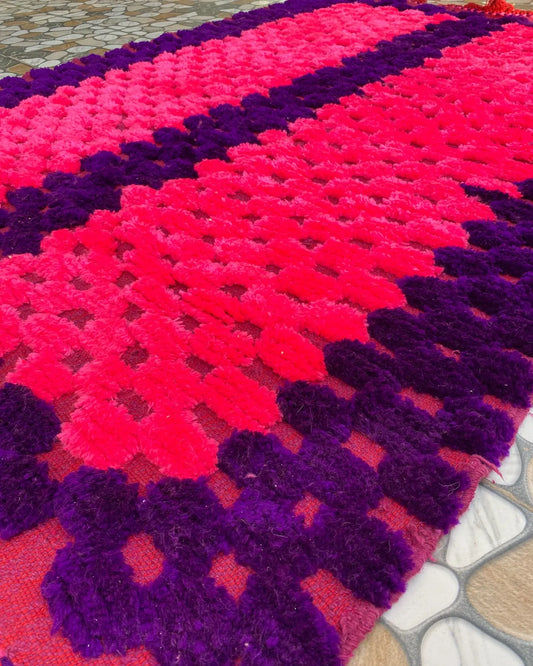 Hot Pink and Purple Boujad Rug, seen at an angle on the workshop floor