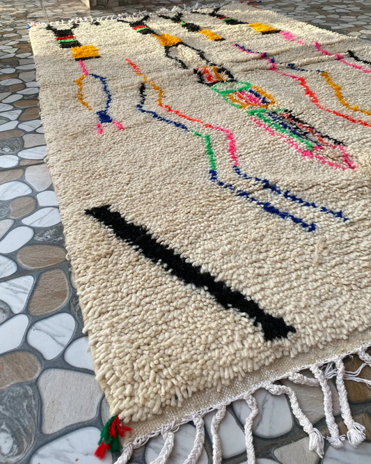 Ivory Line Art Azilal Rug, seen at an angle on the workshop floor