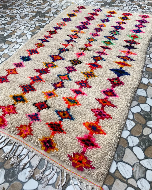 Multicolor Diamond Azilal Rug, seen at an angle on the workshop floor