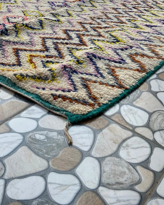 Multicolor Zigzag Moroccan Rug, seen at an angle on the workshop floor