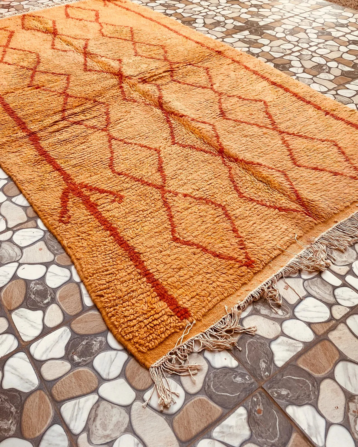 Mustard Yellow Diamond Moroccan Rug, seen at an angle on the workshop floor