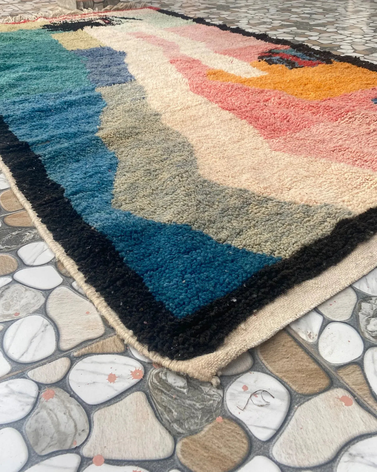 Pastel Abstract Art Moroccan Rug, seen at an angle on the workshop floor