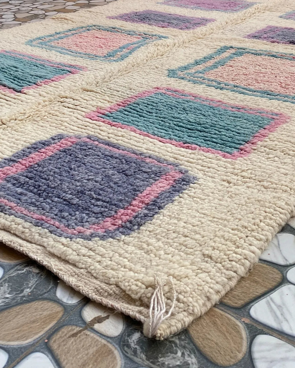 Pastel Square Moroccan Rug, seen at an angle on the workshop floor