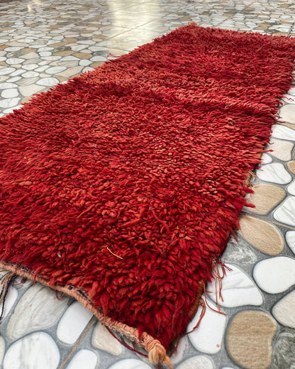 Red Shag Moroccan Runner, seen at an angle on the workshop floor