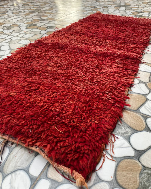 Red Shag Moroccan Runner, seen at an angle on the workshop floor