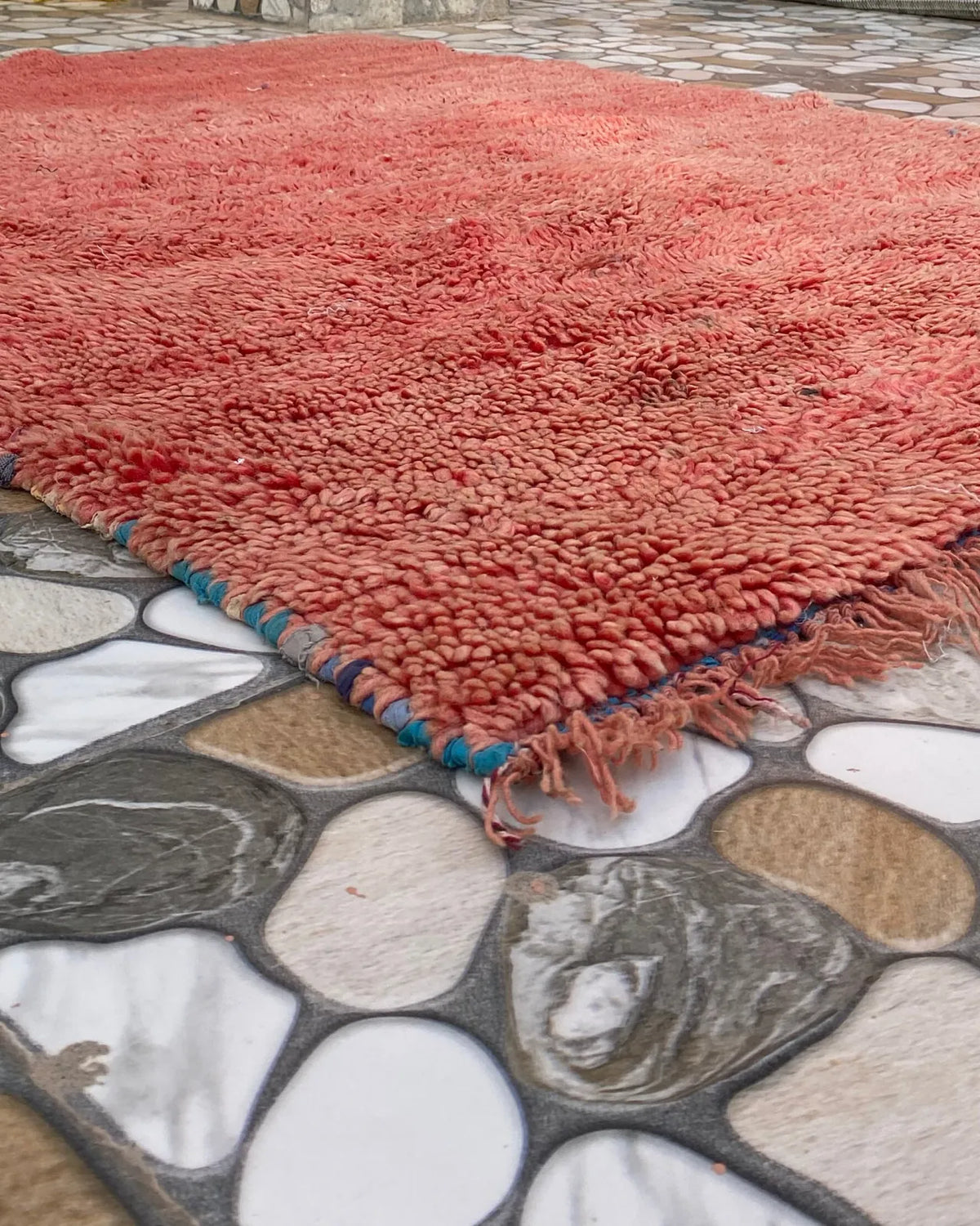 Rust Red Plain Beni Ourain Rug, seen at an angle on the workshop floor